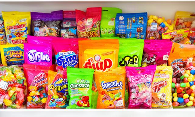 Colourful American and international candy packages arranged on a bright shop shelf