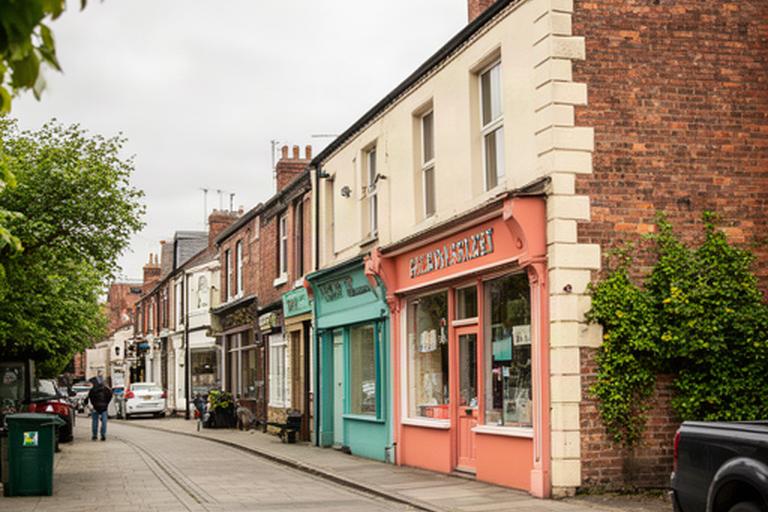 Flora Street in Wigan near 2A Flora Street, showing the local high-street setting around Varley & Vickers Treats