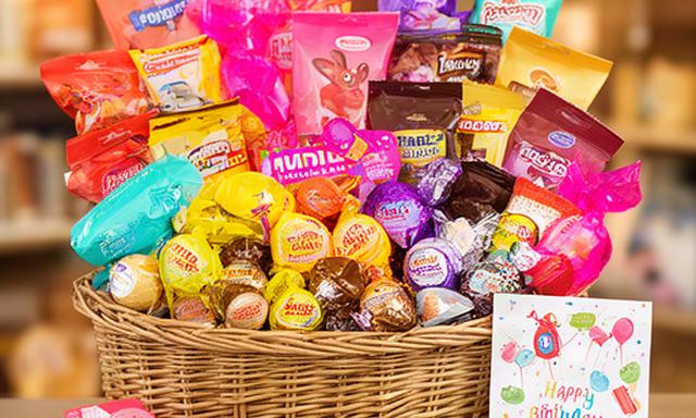Birthday sweet hamper filled with colourful sweets and a small birthday card
