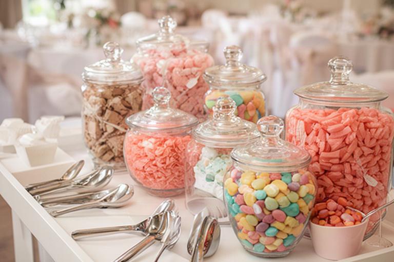 Colour-themed sweet cart prepared for a Wigan wedding reception with jars and serving scoops